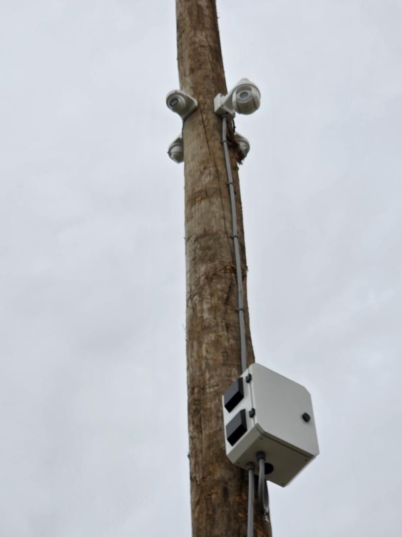 Multiple HD security cameras mounted on power pole with junction box
